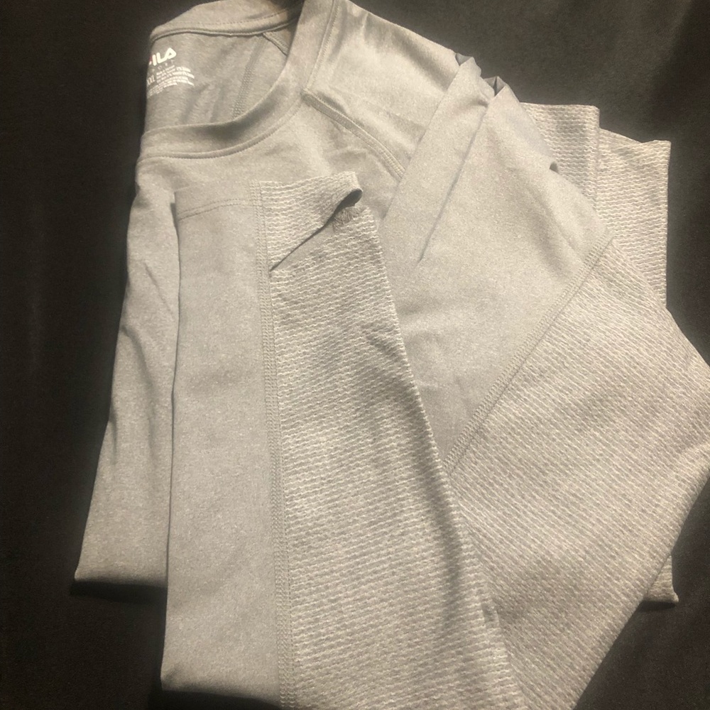 Fila brand , gray long sleeve shirt with Thumb slots . Never worn , no tags